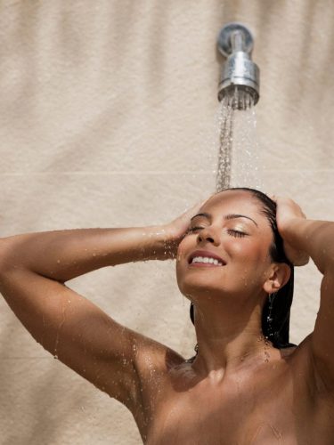 woman showering shampoo rinse